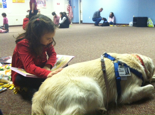 Child reads to Dog