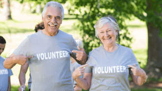Man and woman over age 55 wearing "volunteer" t-shirts