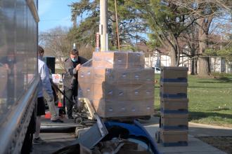 loading pallet of boxes onto truck outside the library for temporary storage