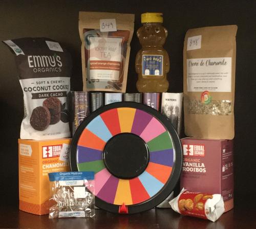 prize spinner surrounded by treats and tea