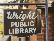 Vintage "Wright Public Library" sign from the front sidewalk